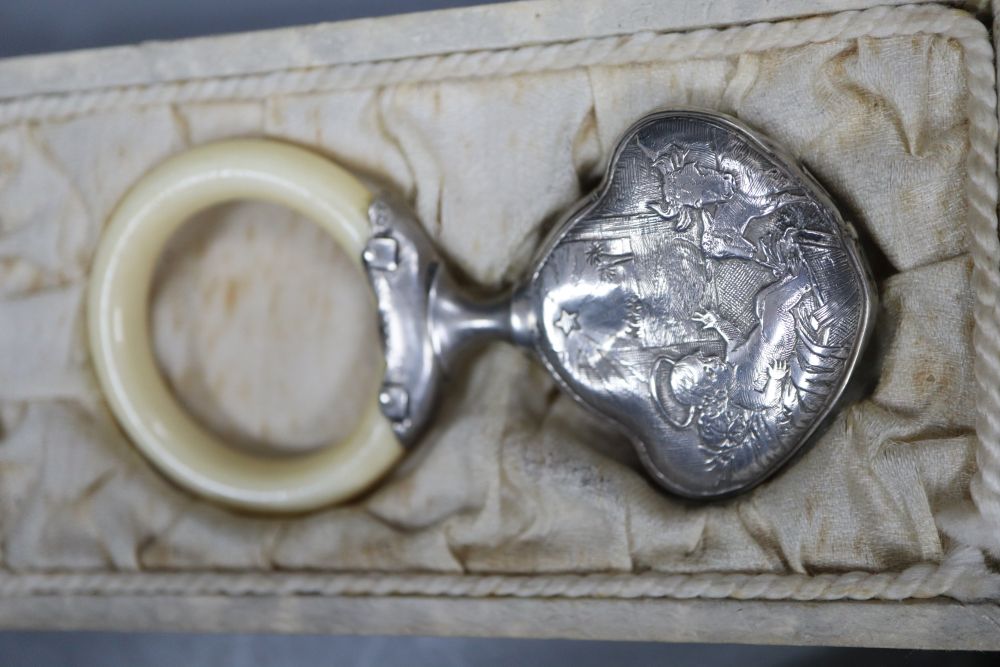 Three assorted white metal topped glass scent bottles including one silver and a childs white metal and ivory teether.